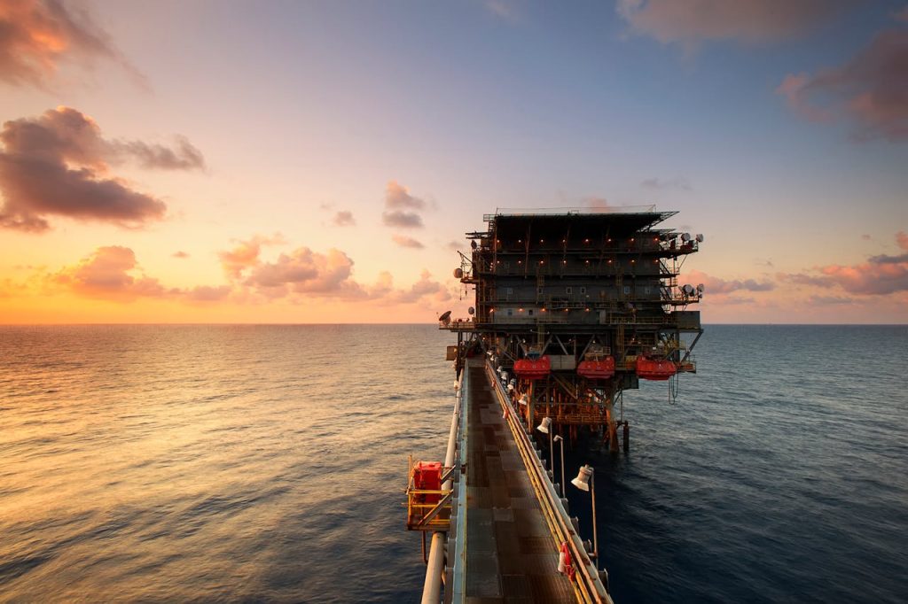 offshore-drilling-rig-on-body-of-water-87236 A breathtaking view of an oil platform on the ocean at sunset, showcasing industrial beauty.